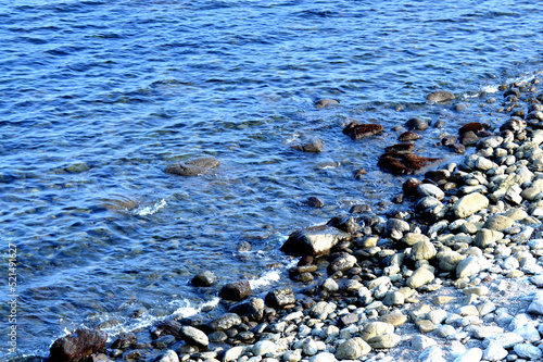 Beautiful romantic photo, seashore on the beach. Relaxing seascape. Waves with foam on the sea. Summer sunny day. Vacation spirit. Beautiful landscape. Nature background. 