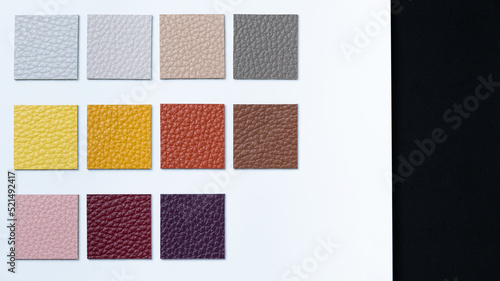 High quality sample book of vegetable tanned leather on black background for leather industry with hot tone.