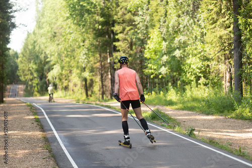 Man ride roller skis in the autumn Park. © Александр Поташев