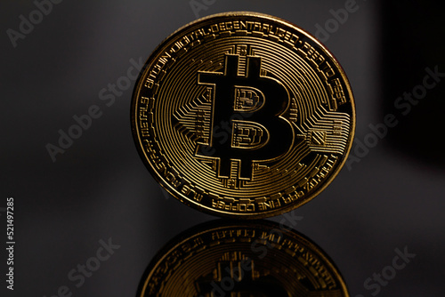 Cryptocurrency market concept. Cryptocurrency - bitcoin coin. Bitcoin is the coin of the future. Bitcoin and its reflection. Gold coin on a black background. Trading. Macro photography. Close-up.