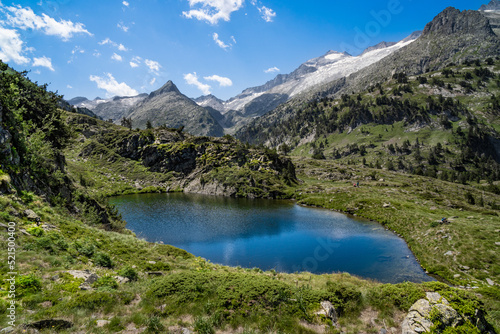 Spectacular, wonderful and evocative landscape of a lake in the Pyrenees surrounded by mountains and snow-capped peaks of Benasque. In HDR color.