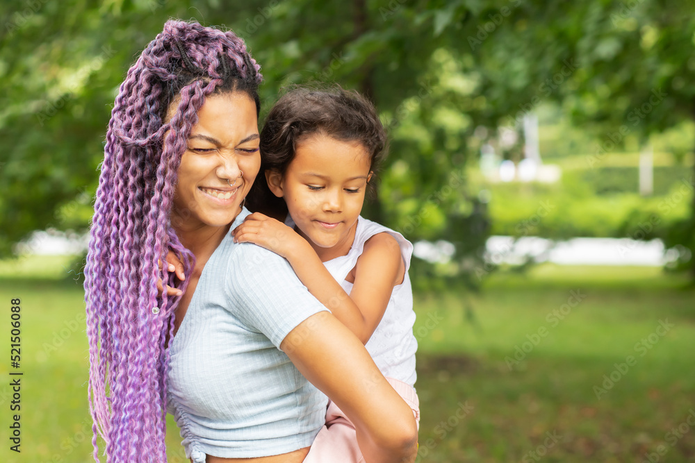 happy family, african mother having fun with her daughter in the park, a woman with a child playing in nature in summer happy family, african mother having fun with her daughter in the park, a woman with a child playing in nature in summer