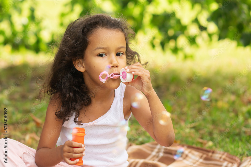 happy african american child outside, girl blowing bubbles, happiness and childhood happy african american child outside, girl blowing bubbles, happiness and childhood