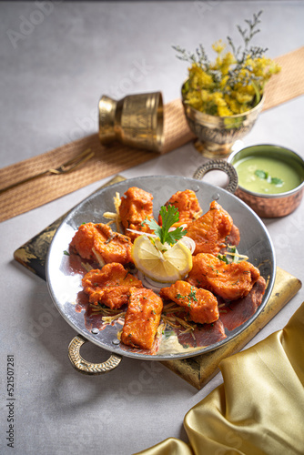 Amritsari fish tikka with raita and lime served in a dish isolated on dark background side view of fastfood