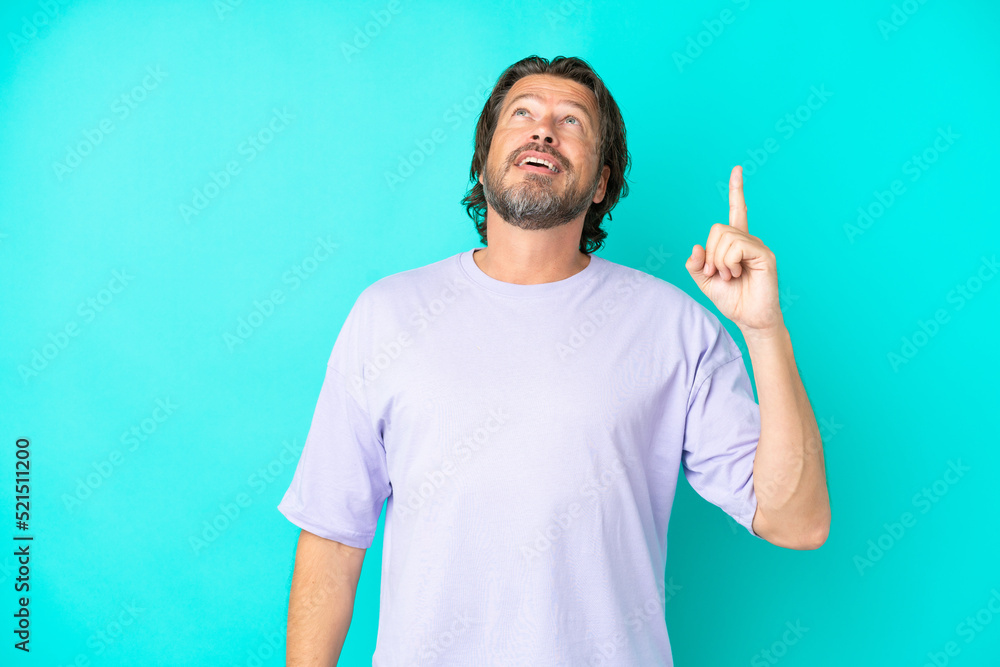 Senior dutch man isolated on blue background pointing up and surprised Senior dutch man isolated on blue background pointing up and surprised