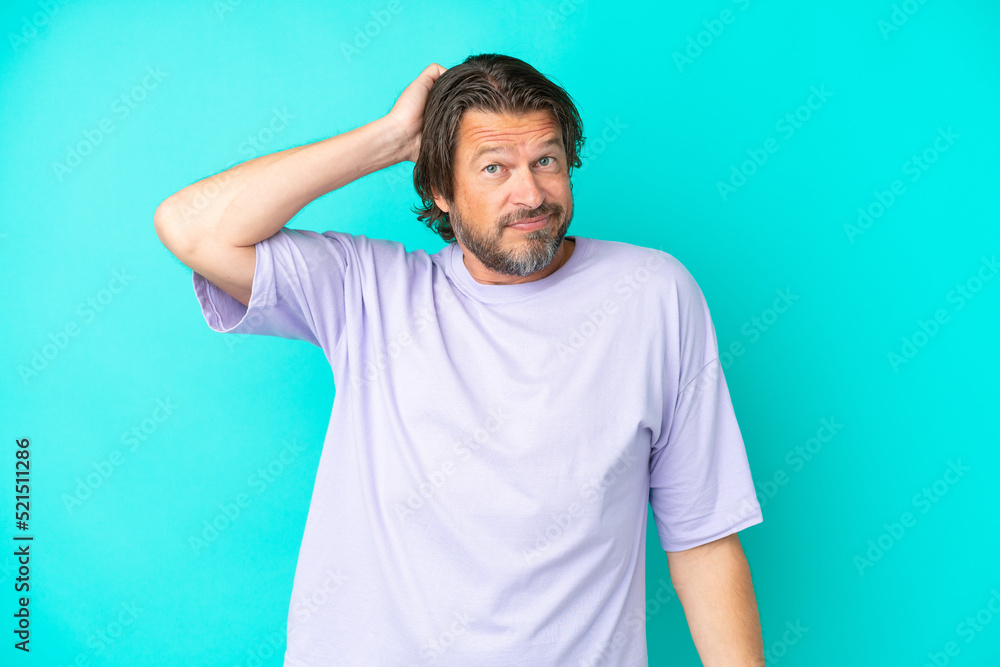 Senior dutch man isolated on blue background with an expression of frustration and not understanding Senior dutch man isolated on blue background with an expression of frustration and not understanding