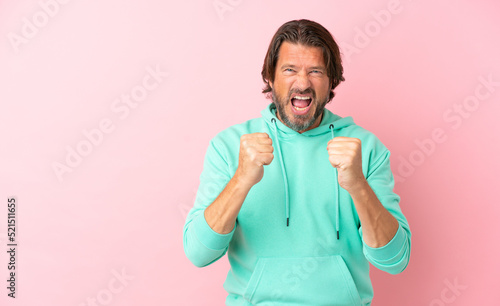 Senior dutch man isolated on pink background frustrated by a bad situation