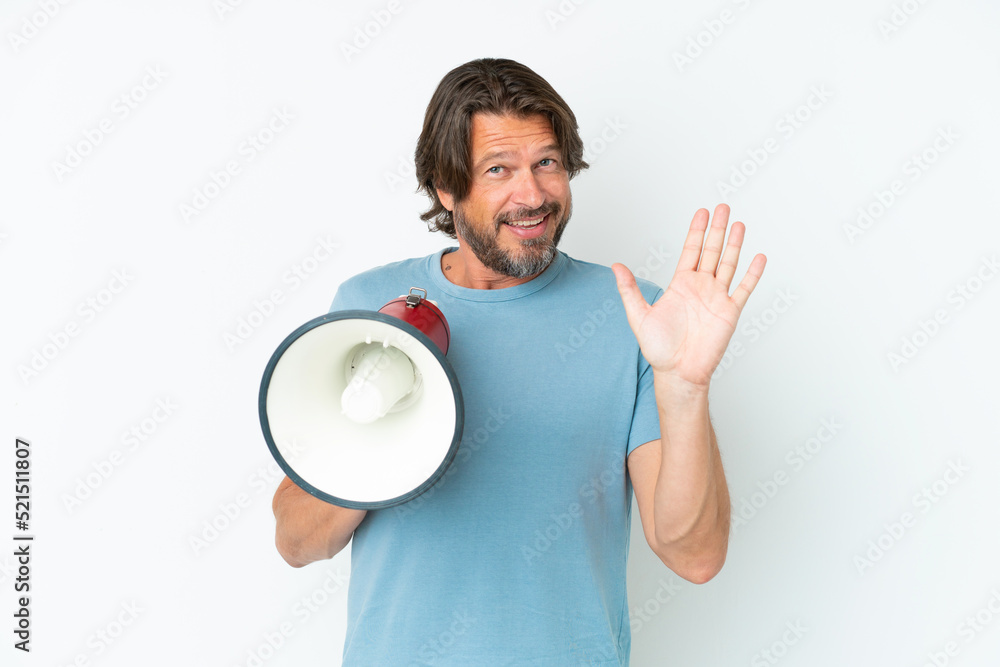 Senior dutch man isolated on white background holding a megaphone and saluting with hand with happy expression Senior dutch man isolated on white background holding a megaphone and saluting with hand with happy expression