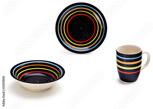 Fun black and colorful ceramic kit with two plates and a mug, isolated on white