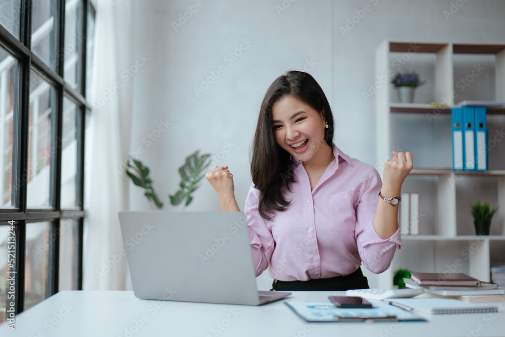 Young business women working and typing on laptop with happy and smile face on office spec. Young business women working and typing on laptop with happy and smile face on office spec.