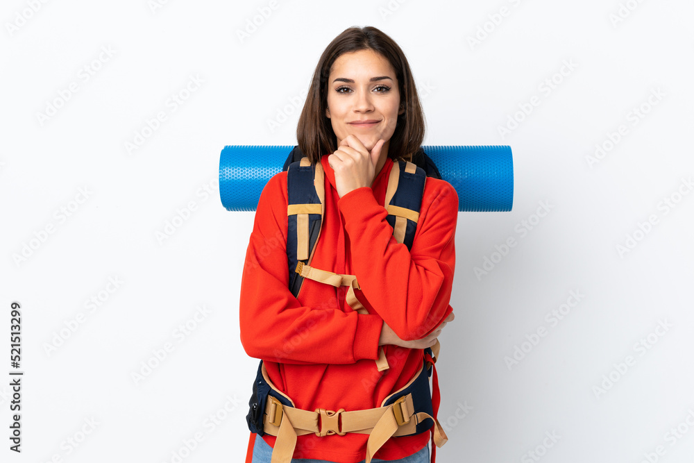 Young caucasian mountaineer girl with a big backpack isolated on white background laughing Young caucasian mountaineer girl with a big backpack isolated on white background laughing