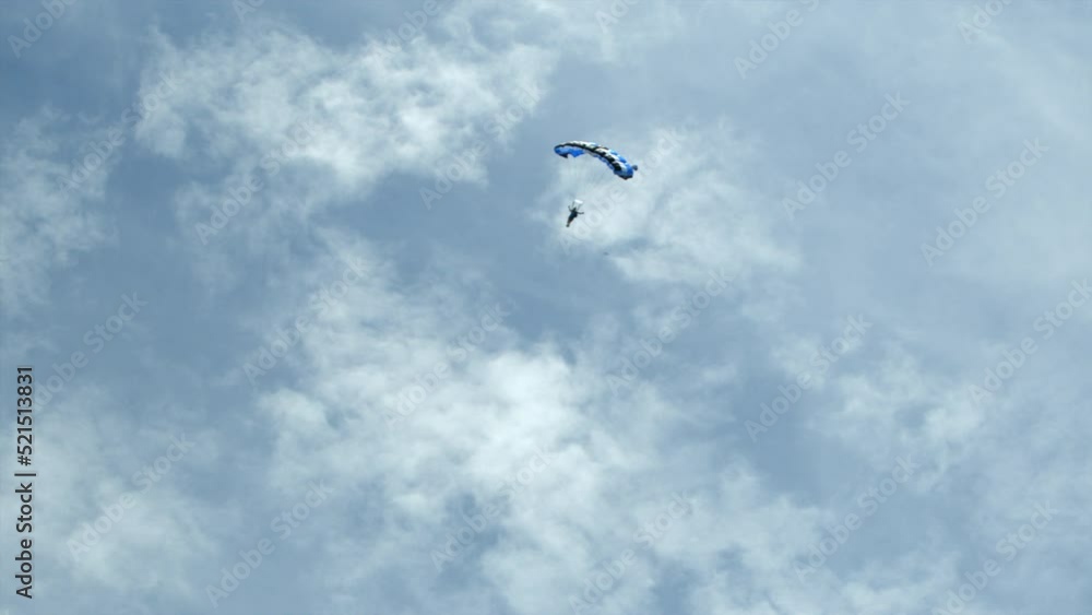 Panning A Man Hanging From A Parachute As He Soars And Spins Through The Sky - Panama City, Panama Panning A Man Hanging From A Parachute As He Soars And Spins Through The Sky - Panama City, Panama