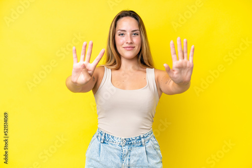Young caucasian woman isolated on yellow background counting nine with fingers