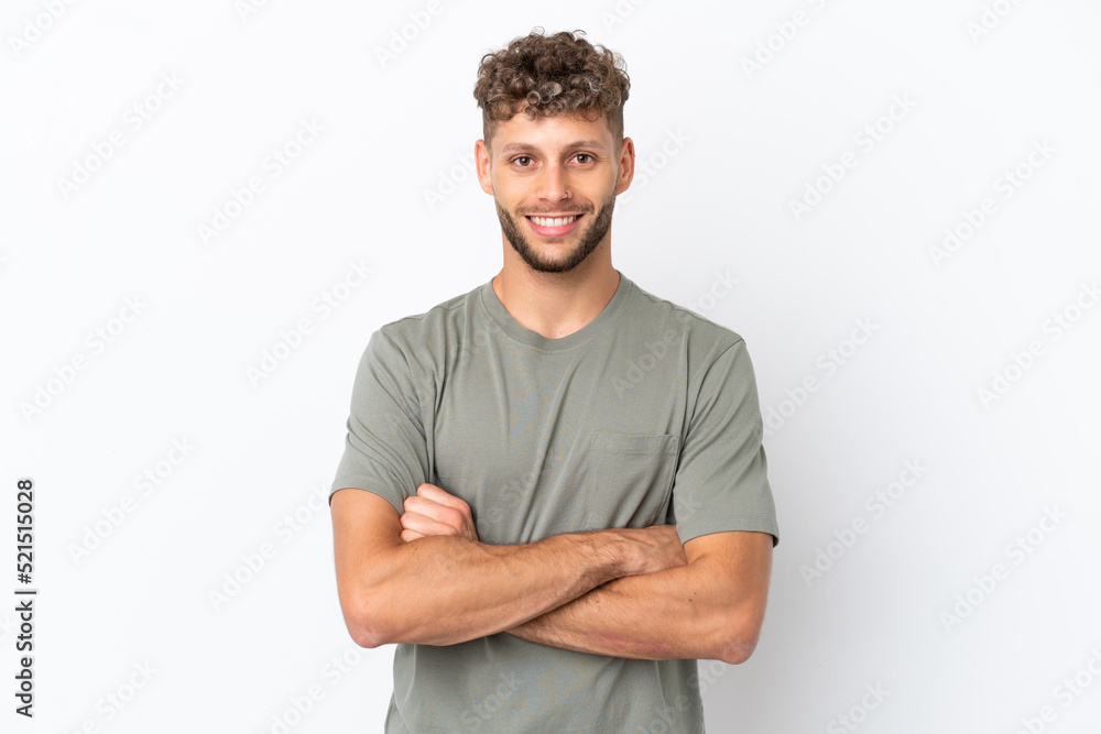 Obraz premium Young caucasian handsome man isolated on white background keeping the arms crossed in frontal position
