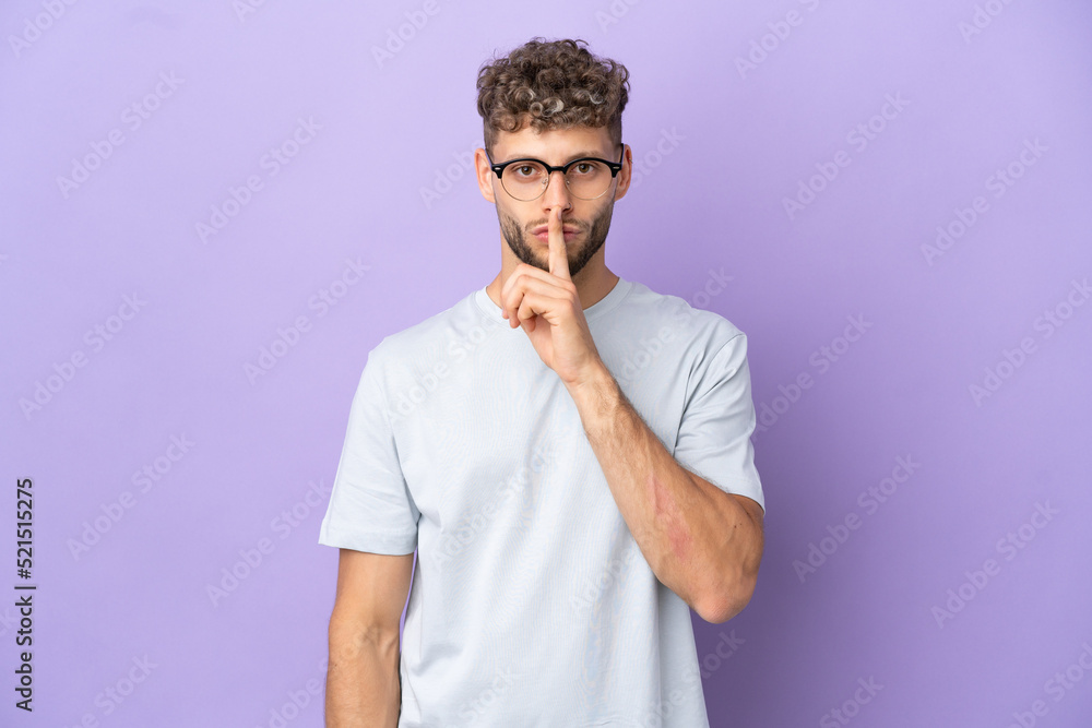 Delivery caucasian man isolated on purple background showing a sign of silence gesture putting finger in mouth Delivery caucasian man isolated on purple background showing a sign of silence gesture putting finger in mouth