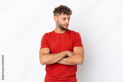 Young caucasian handsome man isolated on white background keeping the arms crossed