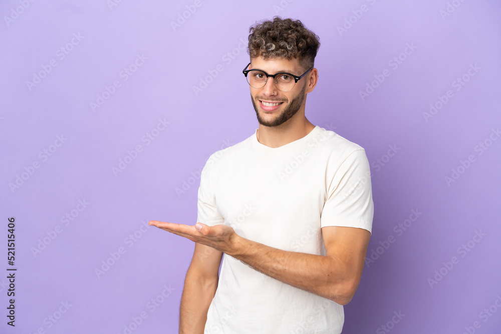 Delivery caucasian man isolated on purple background presenting an idea while looking smiling towards Delivery caucasian man isolated on purple background presenting an idea while looking smiling towards
