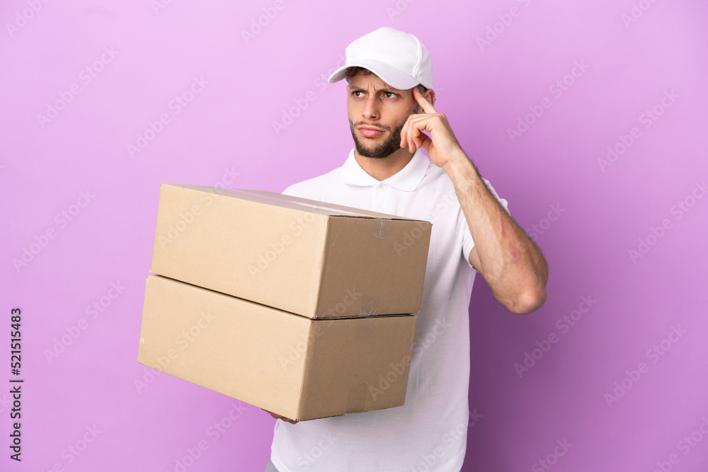 Delivery caucasian man isolated on purple background having doubts and thinking Delivery caucasian man isolated on purple background having doubts and thinking