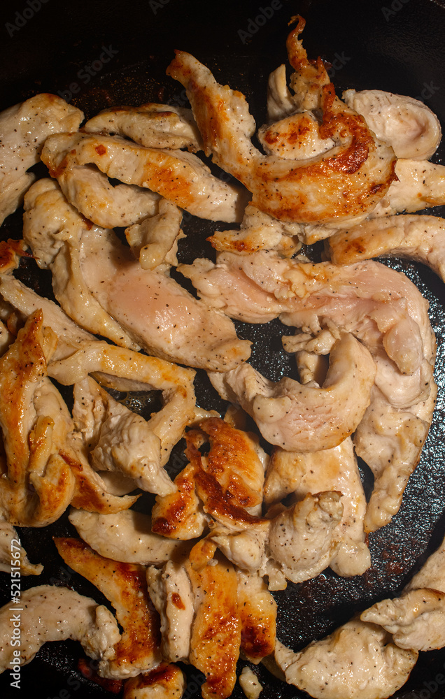 Chicken Strips cooking in a frying pan Chicken Strips cooking in a frying pan