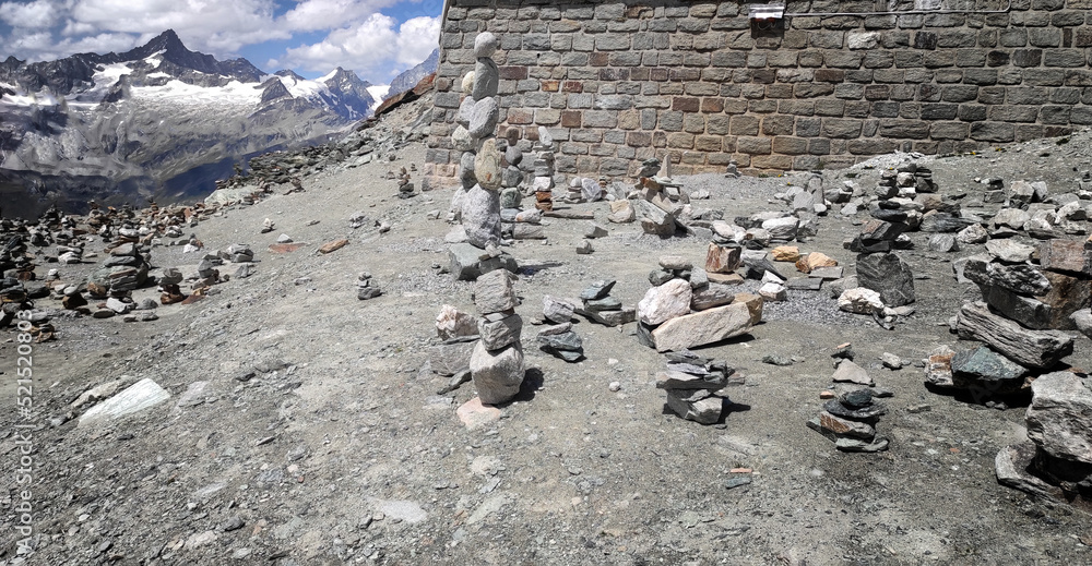 Fototapeta premium Stack of stones on top of the mountain. Pile of rocks stone and mountains. Balanced stone pyramid or Stacked stone or mountain stones tower. Stones arranged for meditation. Represent spirit of Zen.