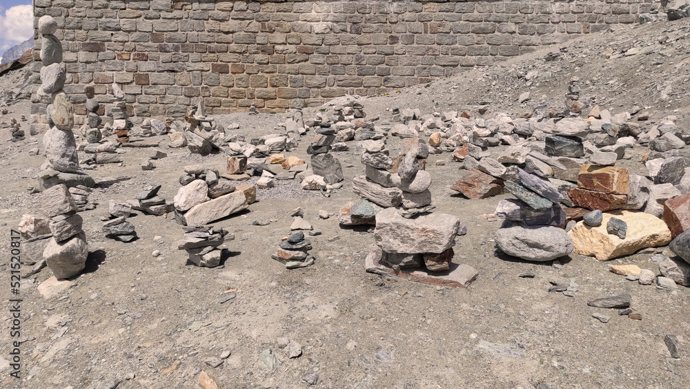 Fototapeta premium Stack of stones on top of the mountain. Pile of rocks stone and mountains. Balanced stone pyramid or Stacked stone or mountain stones tower. Stones arranged for meditation. Represent spirit of Zen.