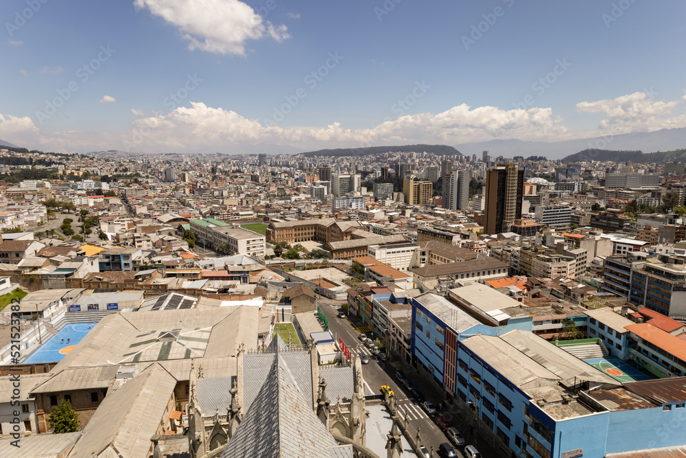 beautiful panoramic aerial landscape of the capital of Ecuador, architecture with mountains in the background, day with clouds, exterior with building