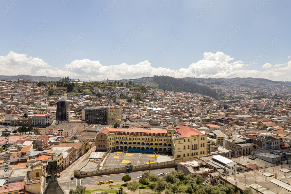 panoramic aerial landscape of the capital of Ecuador, architecture with mountains in the background, day with clouds, exterior with buildings in Latin