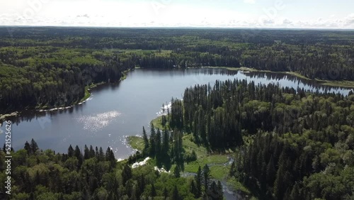 Drone view flyover of lake and forest in Manitoba in the summer photo