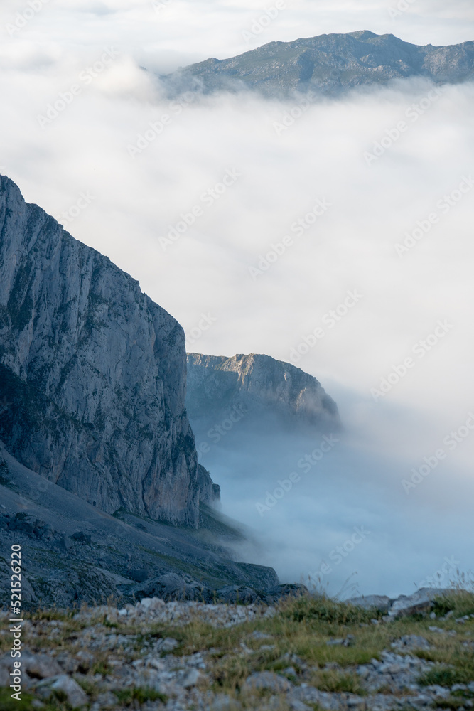 mountain landscape with the mountains over the clouds