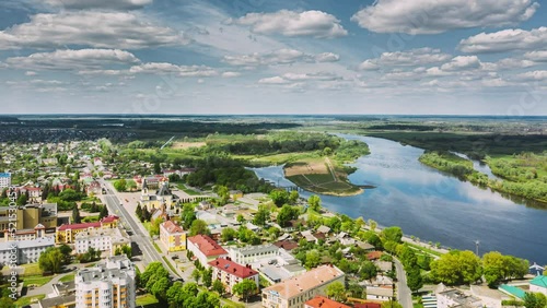 Rechytsa, Belarus. Aerial View Of Residential Houses, River Dnieper And Holy Assumption Cathedral In Sunny Summer Day. Top View. Drone View. Bird's Eye View. Drone Hyper lapse. 4K. photo