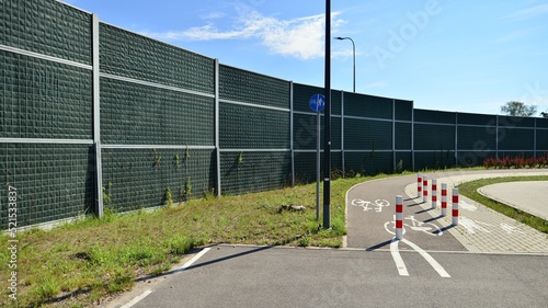 Reducing of noise and sound pollution made by transportation. Narrow road and acoustical barrier.