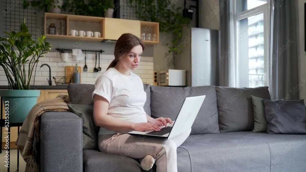 young pregnant business woman works remotely make a meeting, conference, briefing or interview online by video call using webcam laptop computer. Female freelancer is busy at home during pregnancy young pregnant business woman works remotely make a meeting, conference, briefing or interview online by video call using webcam laptop computer. Female freelancer is busy at home during pregnancy
