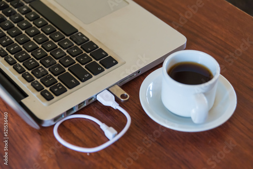 laptop and coffee cup on a wooden table