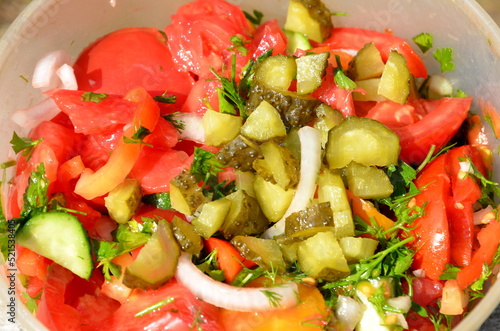 Delicious juicy salad of sliced ​​​​fresh vegetables.