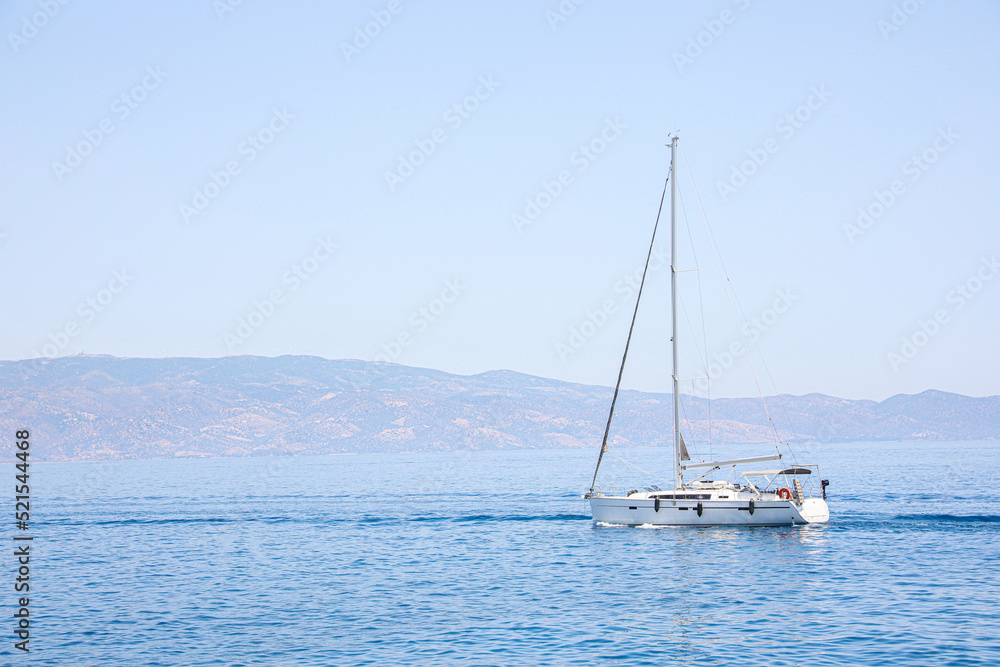 Beautiful seascape with sailboat and distant shore