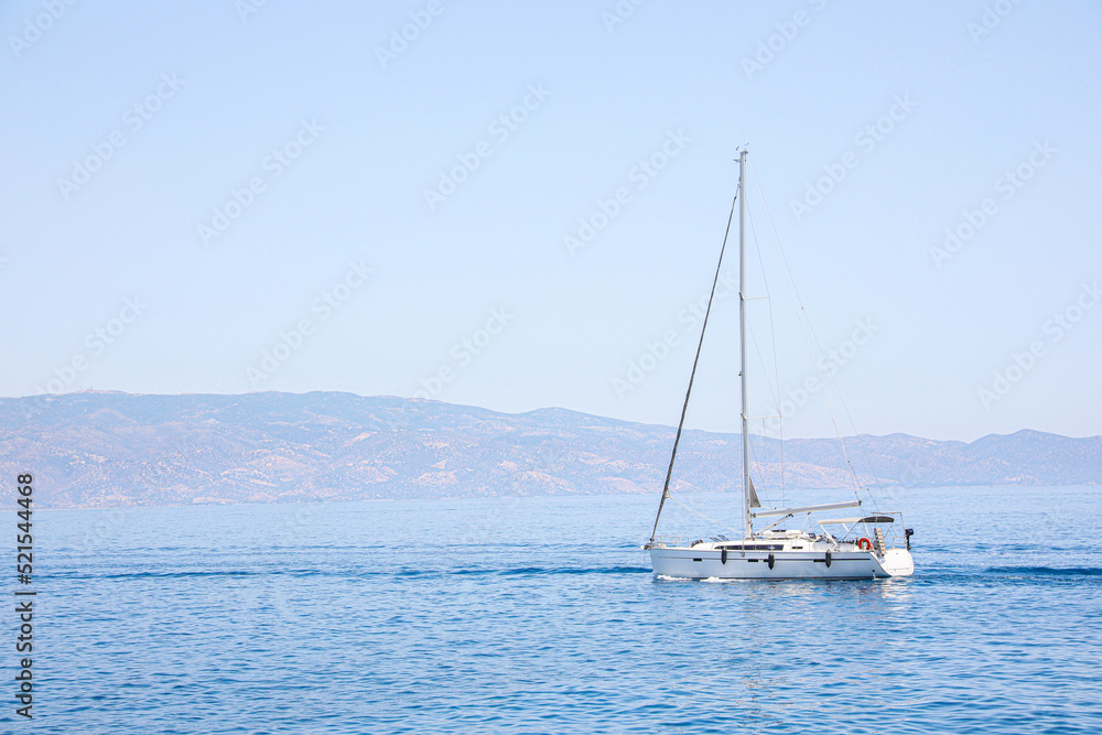 Fototapeta premium Beautiful seascape with sailboat and distant shore