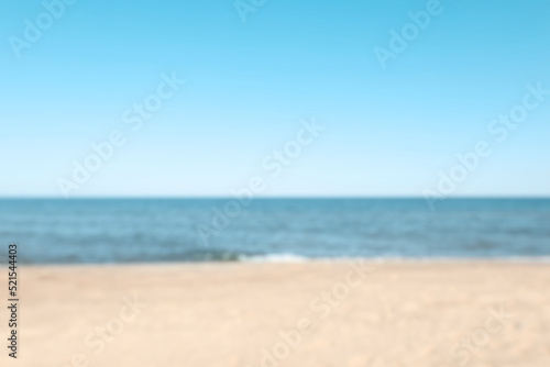 Blurred view of sandy beach near sea