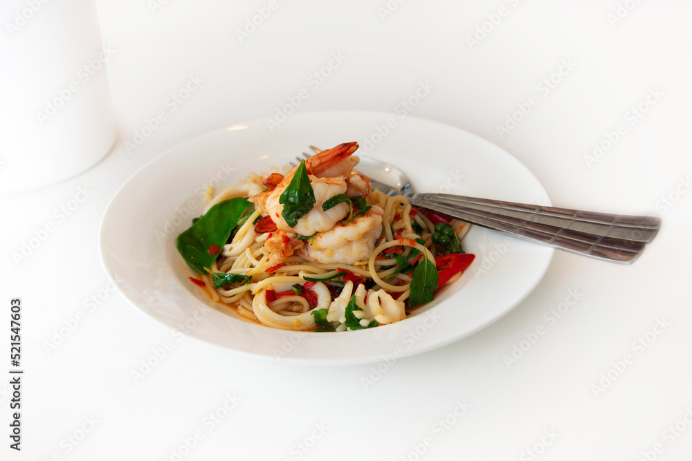 Seafood spaghetti was served on white plate. Seafood spaghetti was served on white plate.