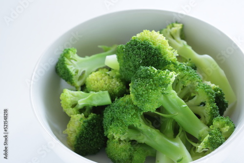 boiled cut prepared broccoli in white background with copy space