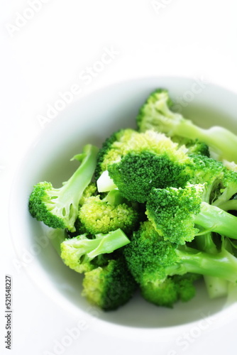 boiled cut prepared broccoli in white background with copy space