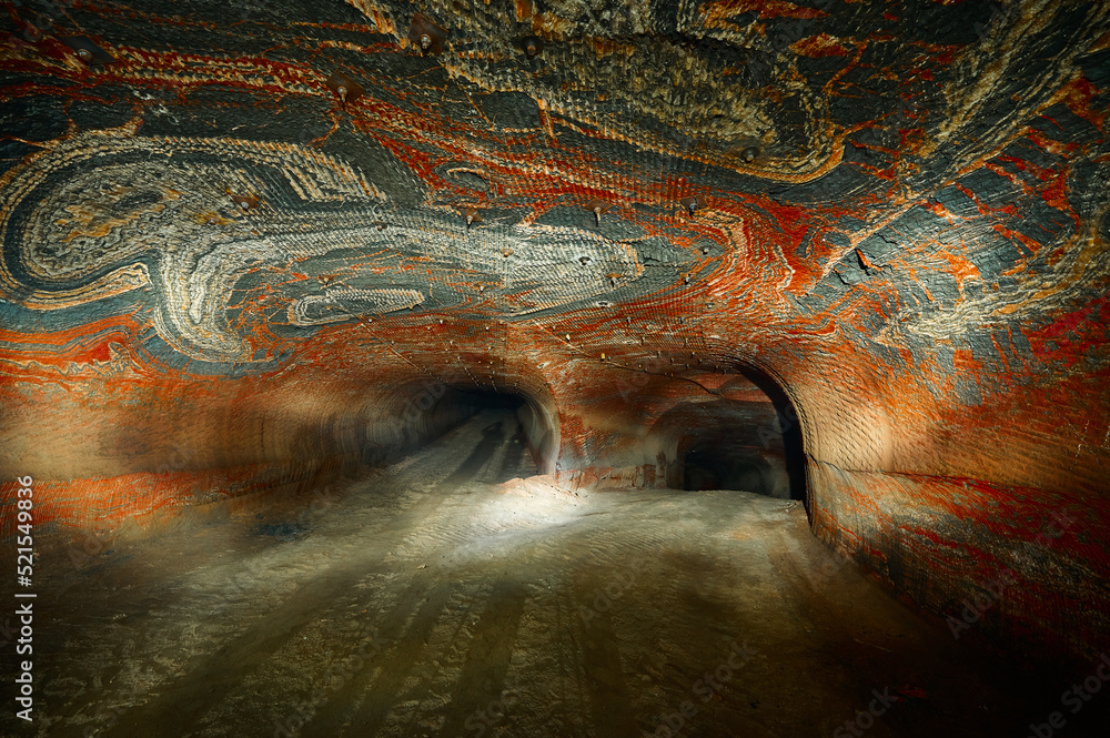 Outgoing tunnel of salt quarry with red patterns on walls Outgoing tunnel of salt quarry with red patterns on walls