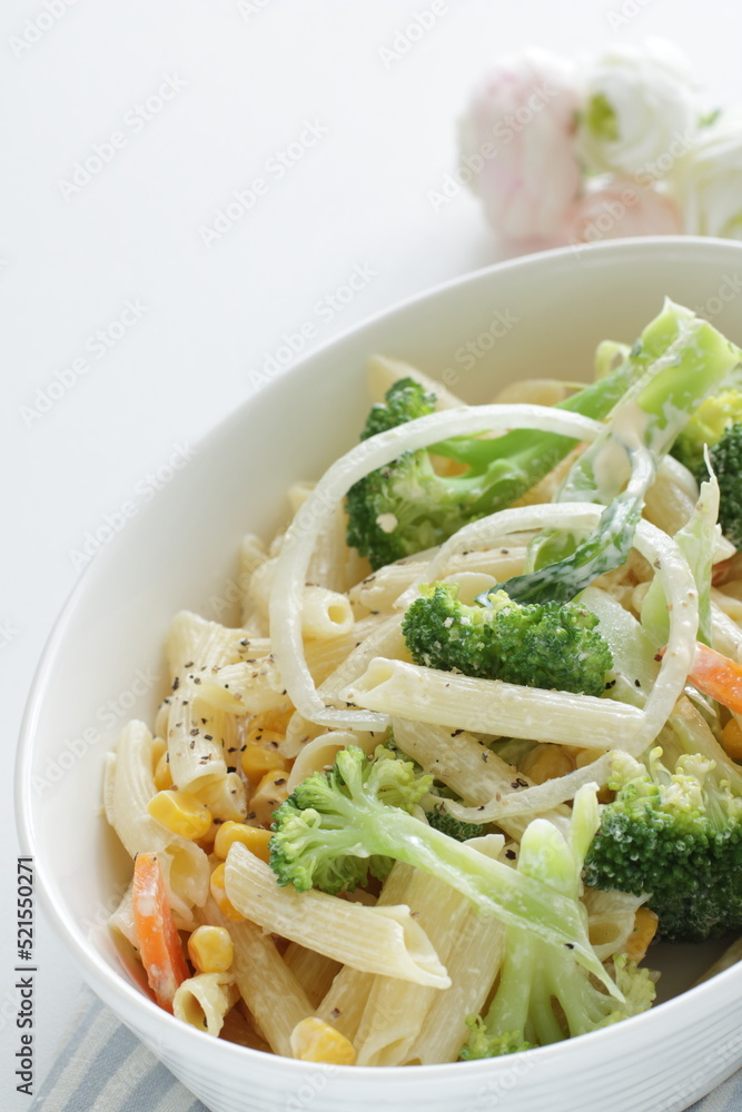 Homemade short pasta and broccoli salad with onion and carrot Homemade short pasta and broccoli salad with onion and carrot