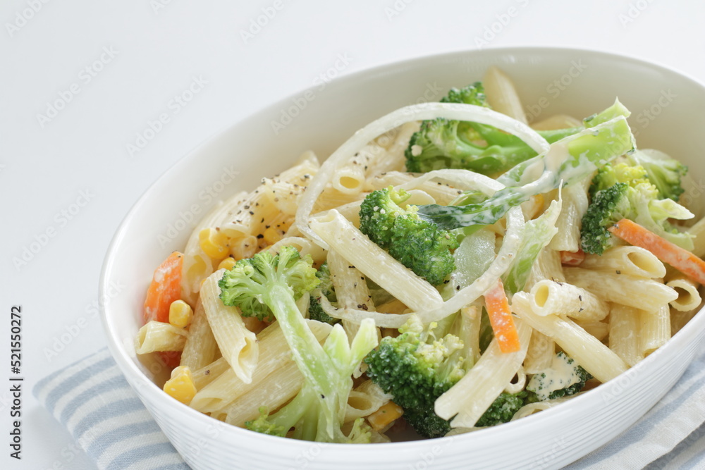 Homemade short pasta and broccoli salad with onion and carrot Homemade short pasta and broccoli salad with onion and carrot