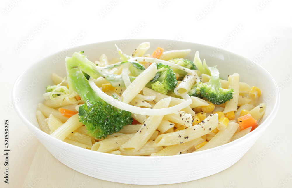 Homemade short pasta and broccoli salad with onion and carrot Homemade short pasta and broccoli salad with onion and carrot