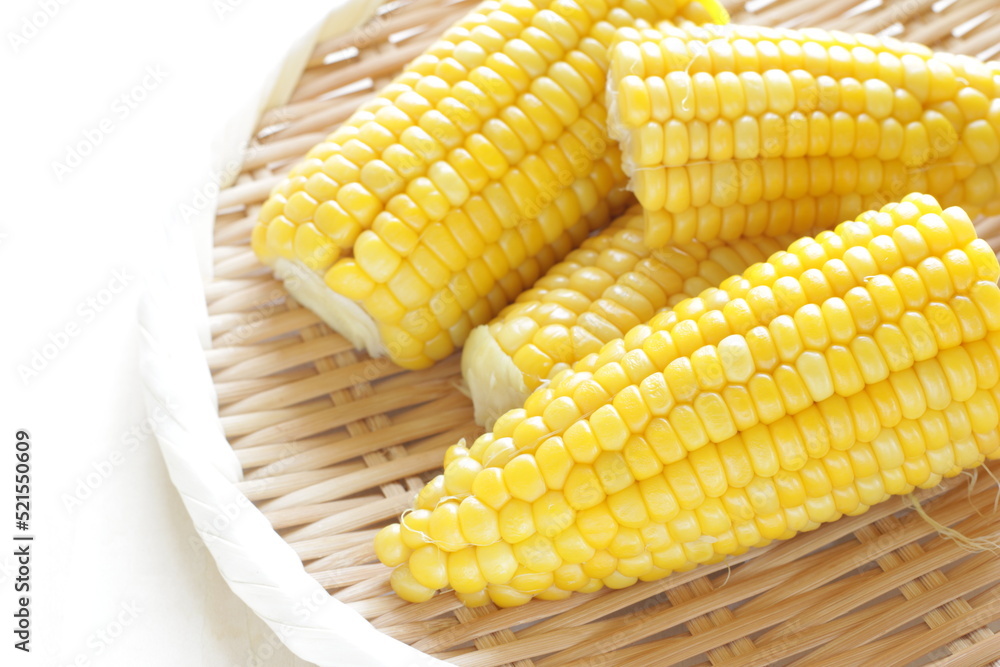 Boiled Japanese sweet corn on bamboo basket with copy space for summer food image Boiled Japanese sweet corn on bamboo basket with copy space for summer food image
