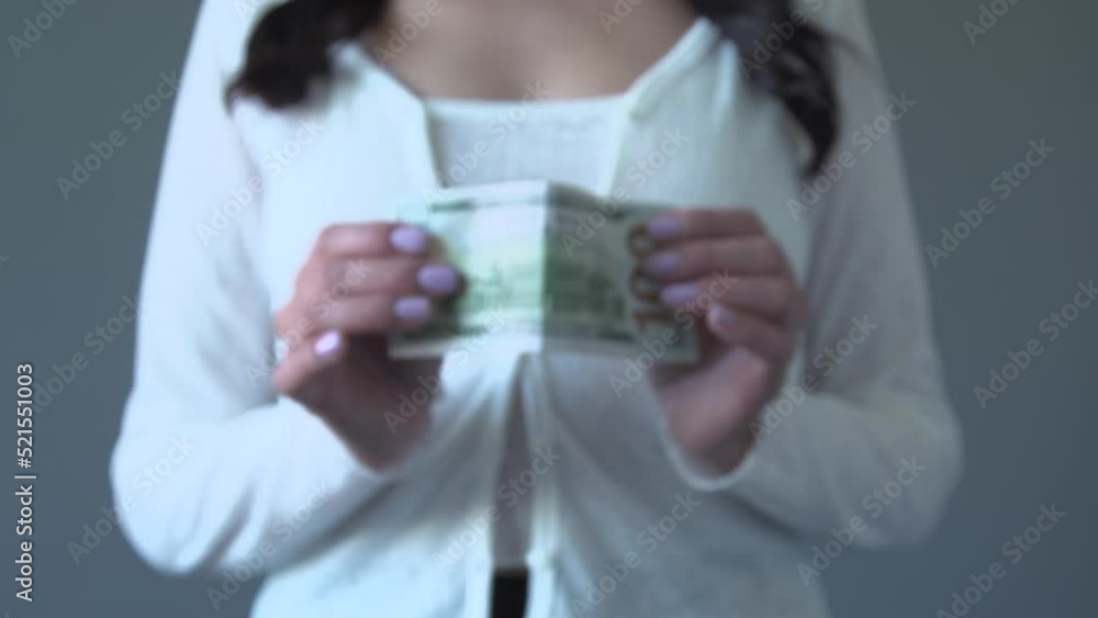 Young woman selec the USD dollar and reject euro eur, israel shekel NIS, Ukrainian hryvnia and Czech koruna CZK banknotes. Currency exchange rate concept. Selective focus Young woman selec the USD dollar and reject euro eur, israel shekel NIS, Ukrainian hryvnia and Czech koruna CZK banknotes. Currency exchange rate concept. Selective focus
