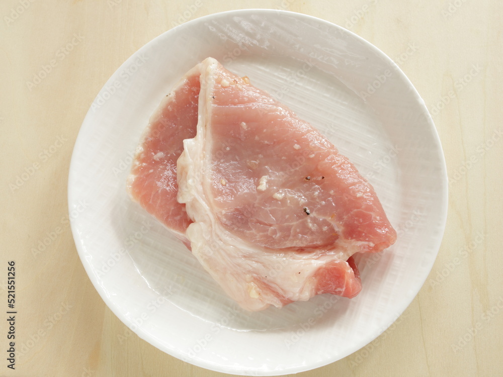 Prepared seasoning pepper and salt on sliced pork Prepared seasoning pepper and salt on sliced pork