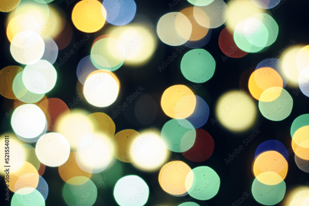 Fototapeta premium multicolored festive lights on a black background screensaver backdrop