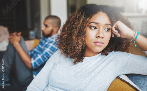 Fotografie Unhappy, angry and stressed couple sitting on a sofa together after arguing