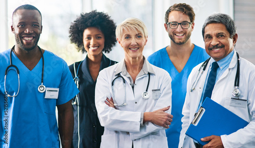 Team or group of a doctor, nurse and medical professional colleagues or coworkers standing in a hospital together. Portrait of diverse healthcare workers looking confident and happy about medicine